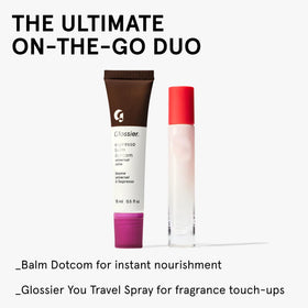 Glossier Balm Dotcom held in hand in transit depicting on-the-go hydration benefit
