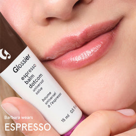 Glossier Balm Dotcom on a nightstand emphasizing bedside hydration and convenience