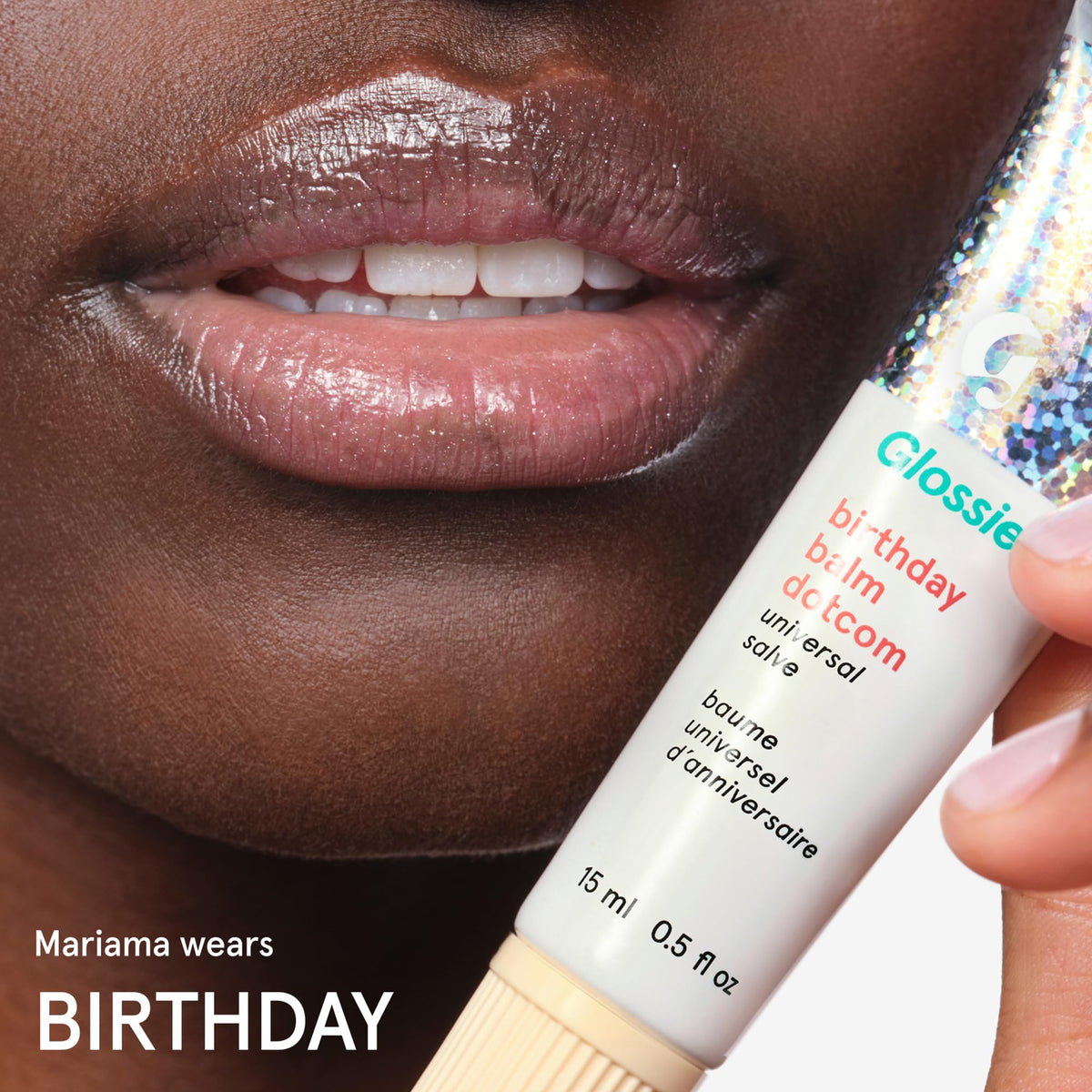 Glossier Balm Dotcom tube beside coin sized for scale and travel-friendly benefit