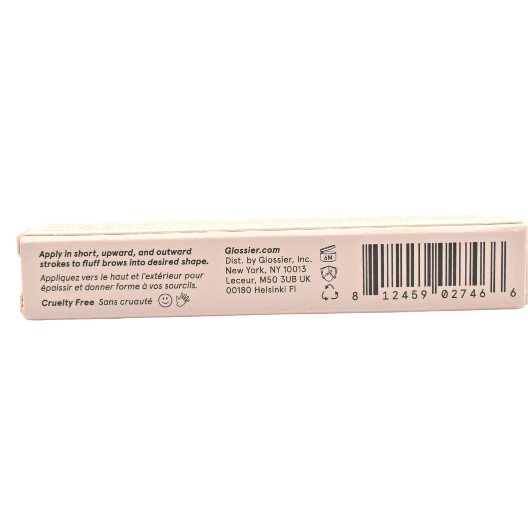 Glossier Boy Brow on model applying clear gel to brows for natural fuller look benefit