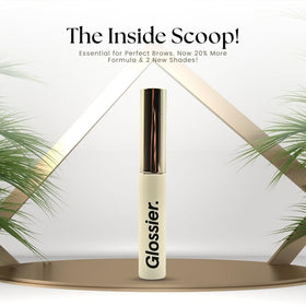 Glossier Boy Brow beside everyday items for size comparison and portability