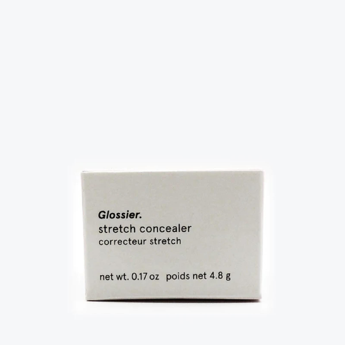 Glossier concealer held in hand to show size and easy on-the-go application