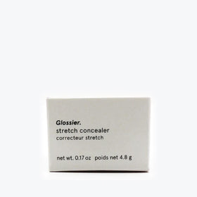Glossier concealer held in hand to show size and easy on-the-go application