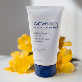 Glowbiotics bottle staged with aloe and safflower showing soothing benefits