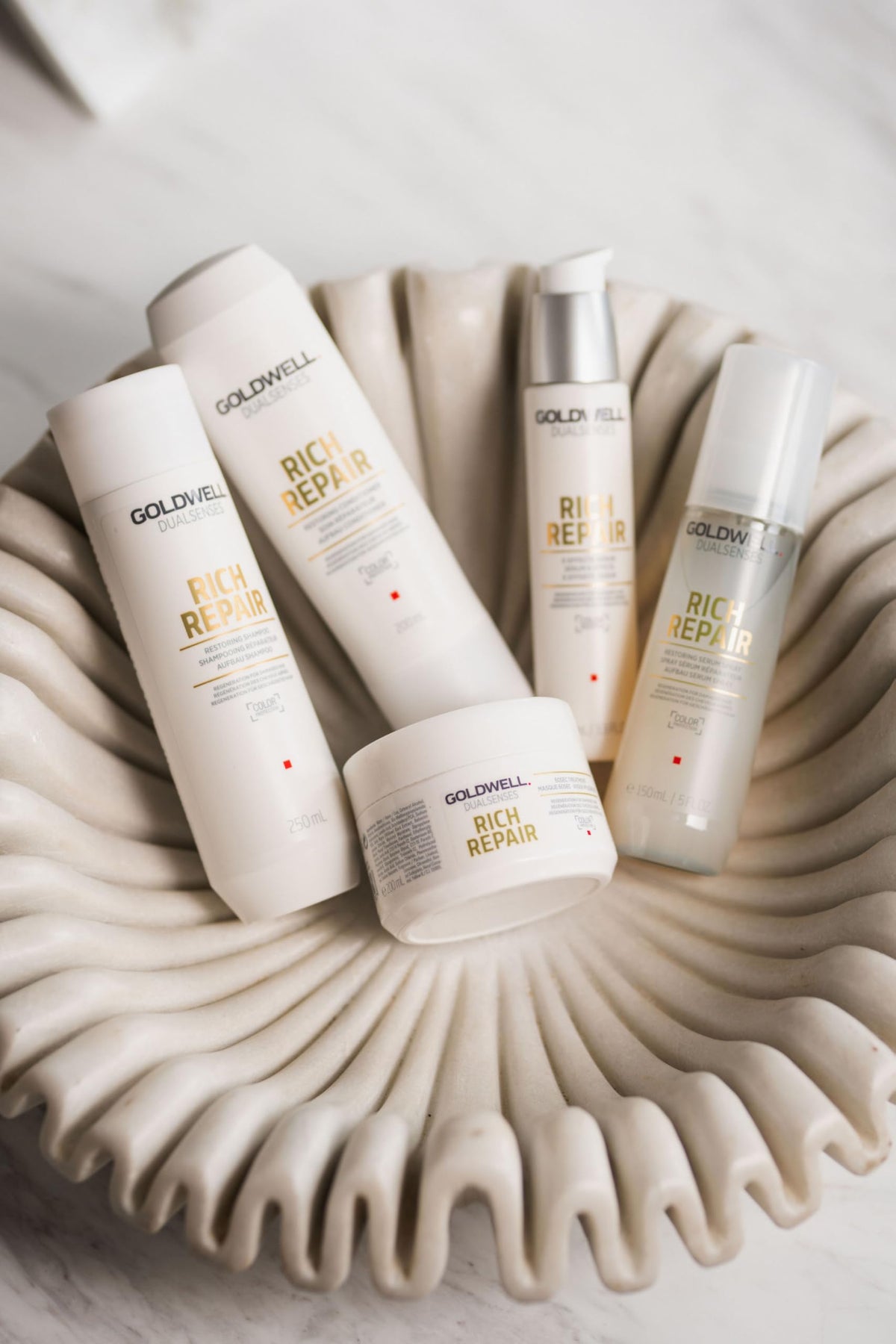 Goldwell conditioner applied in shower demonstrating detangling benefit