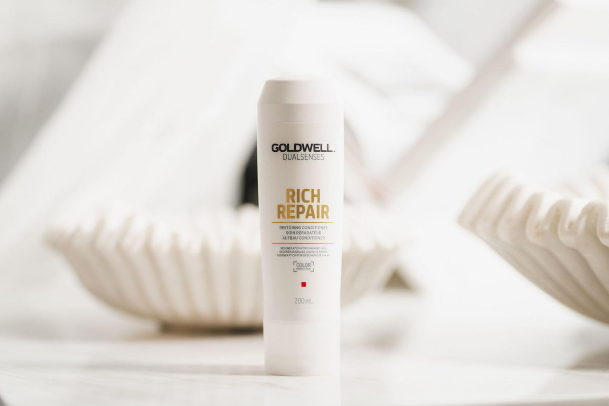 Goldwell 1L bottle in hand showing scale and economical refill advantage