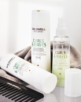 Goldwell bottle held in hand showing 300mL size and practical scale for travel planning