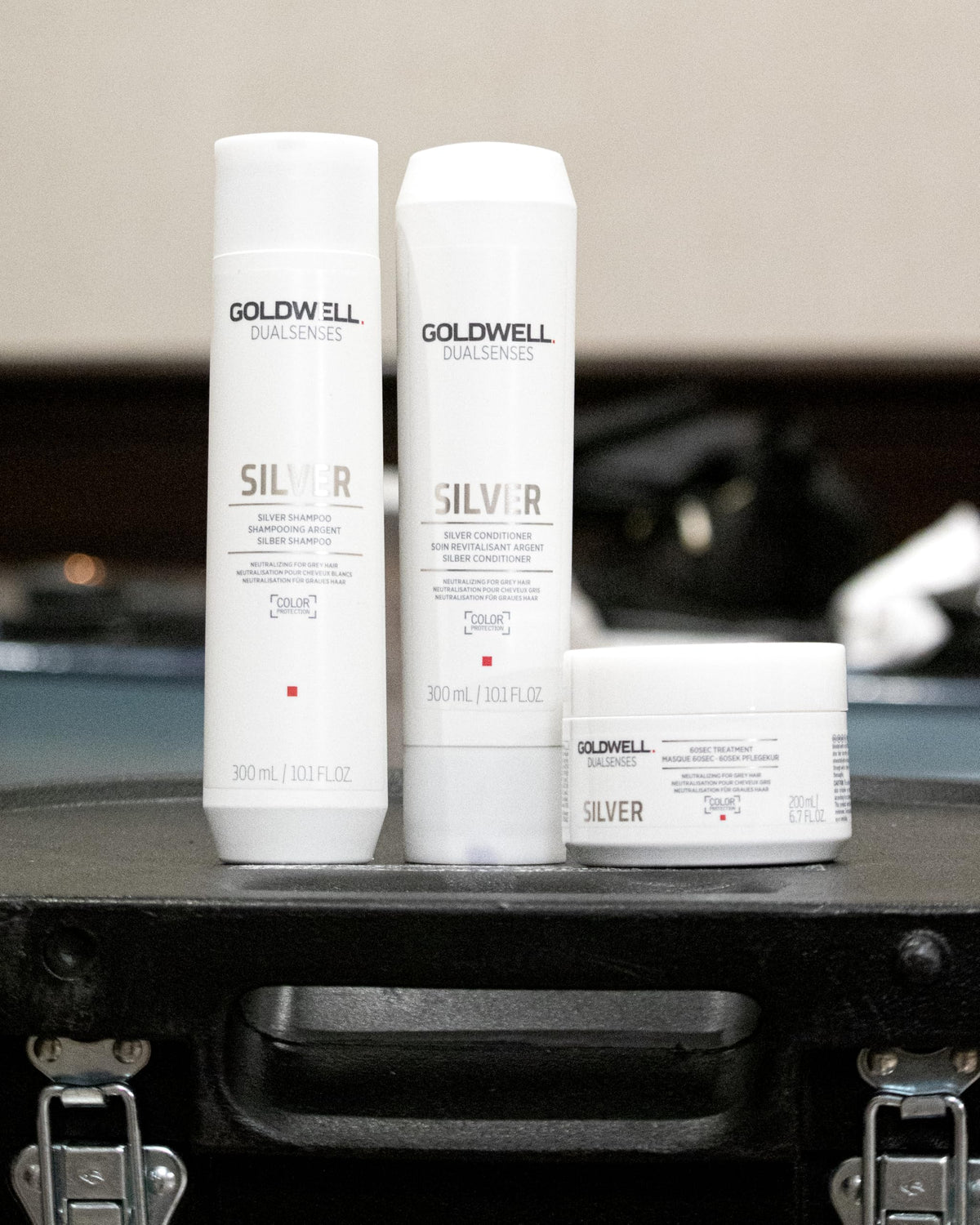Goldwell hand applying shampoo to hair demonstrating even coverage benefit