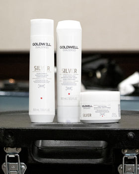 Goldwell hand applying shampoo to hair demonstrating even coverage benefit
