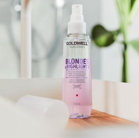 Goldwell 150 mL bottle in hand for scale and travel-friendly convenience