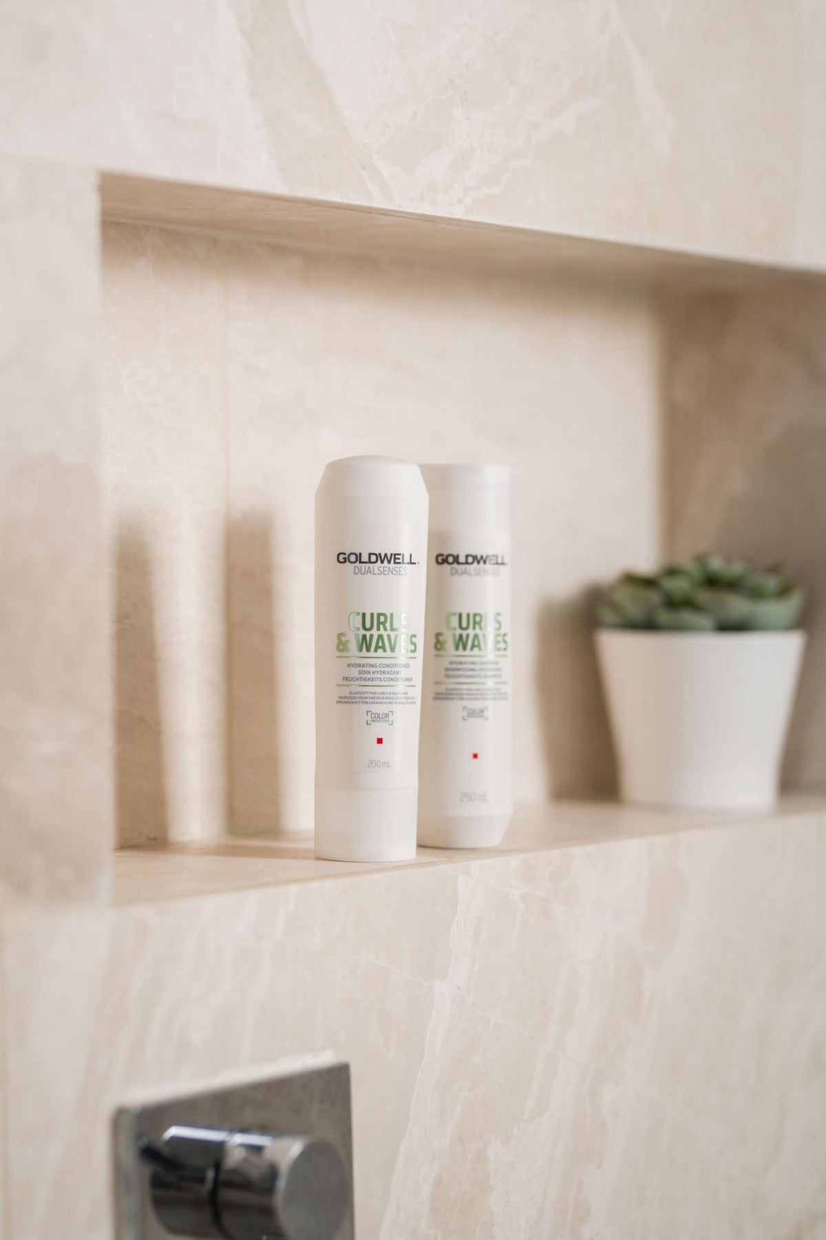 Goldwell 1L bottle beside 250ml for scale and refill convenience