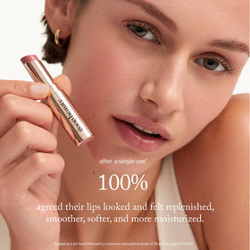 goop size and scale with lip balm next to coin to show travel-friendly compactness
