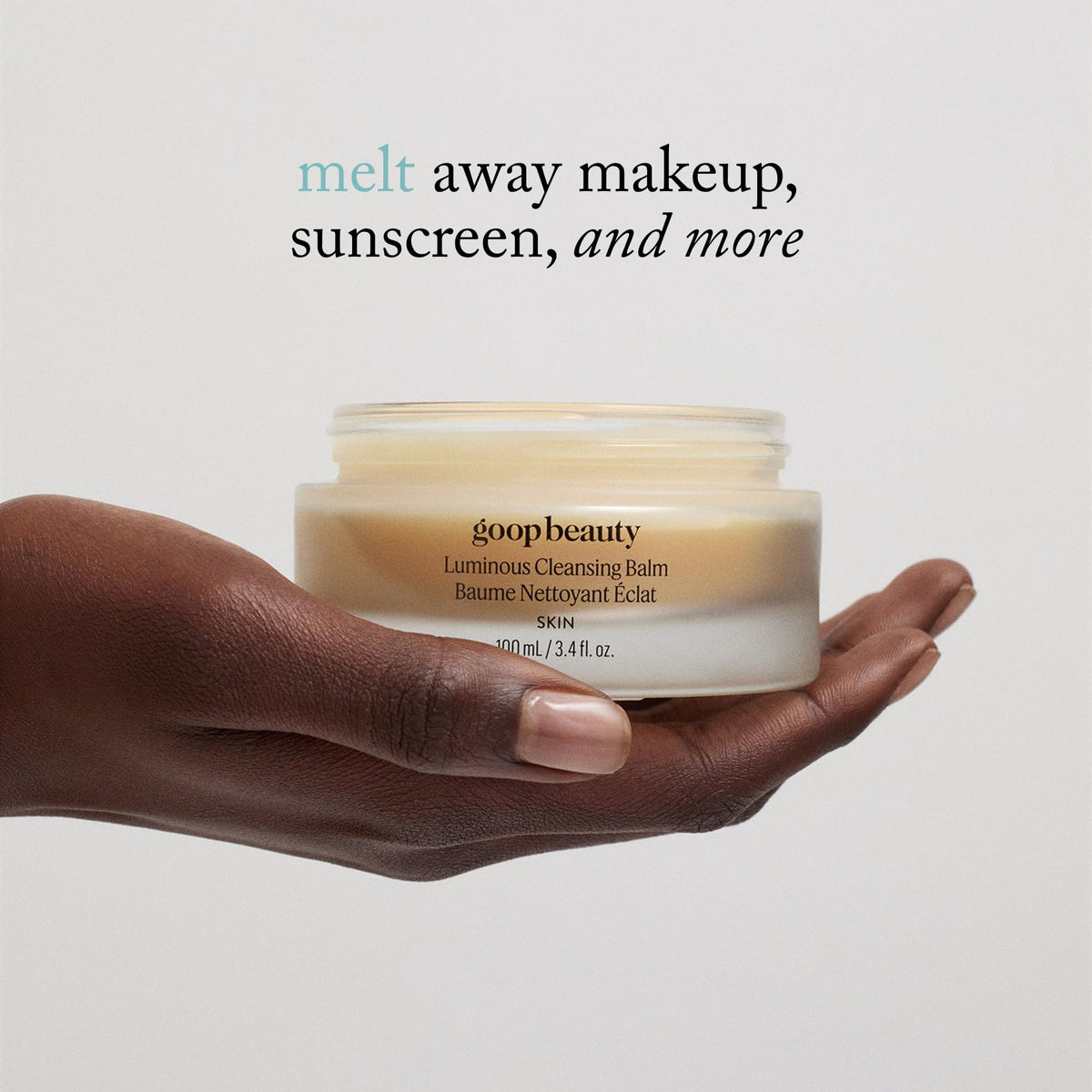 goop cleansing balm held in hand to display 3.4 fl oz size and travel-friendly scale