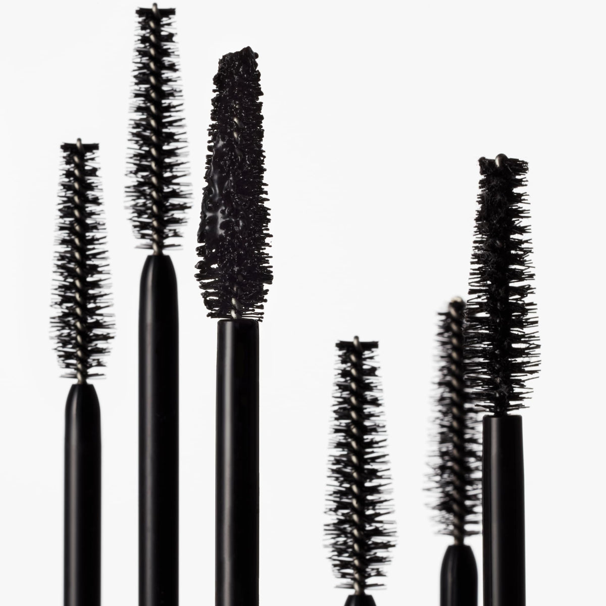 goop Featherlash next to a ruler showing 0.15 fl oz compact travel-friendly size