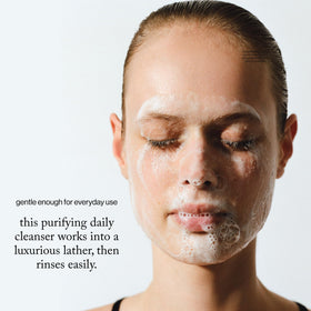 goop cleanser in hand being massaged on skin showing gentle removal