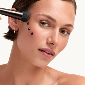 goop Summertone applied on model’s cheek showing instant healthy glow