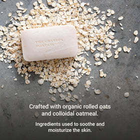 The Grandpa Soap Company rolled oats and chamomile beside the bar highlighting natural ingredients