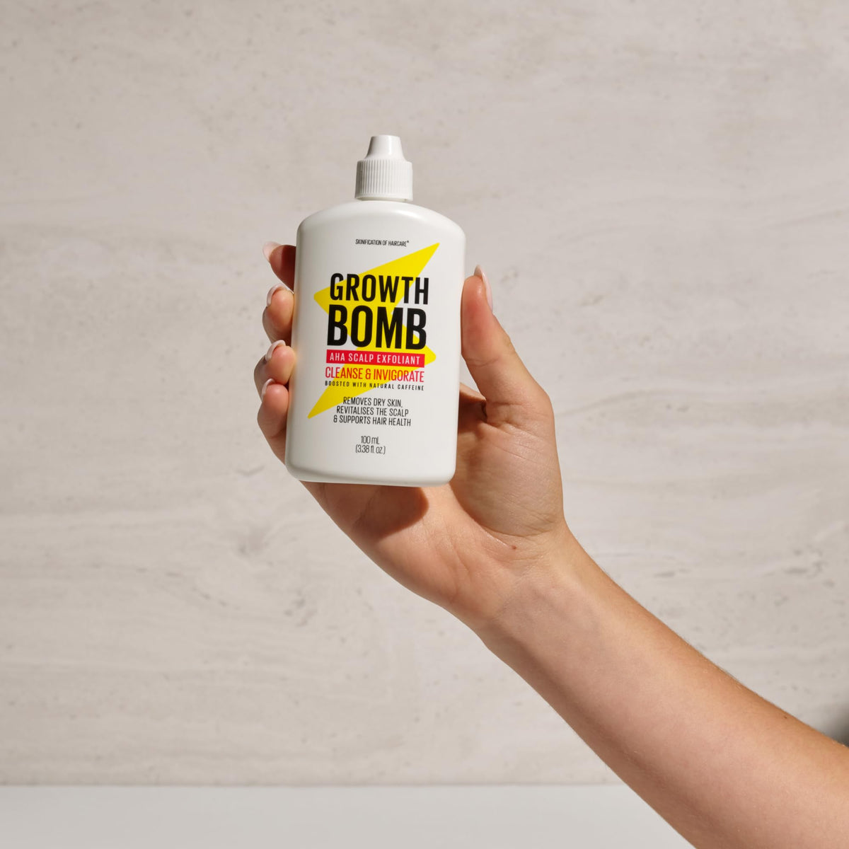 Growth Bomb bottle in hand showing compact 100 mL travel-friendly benefit