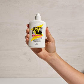 Growth Bomb bottle in hand showing compact 100 mL travel-friendly benefit