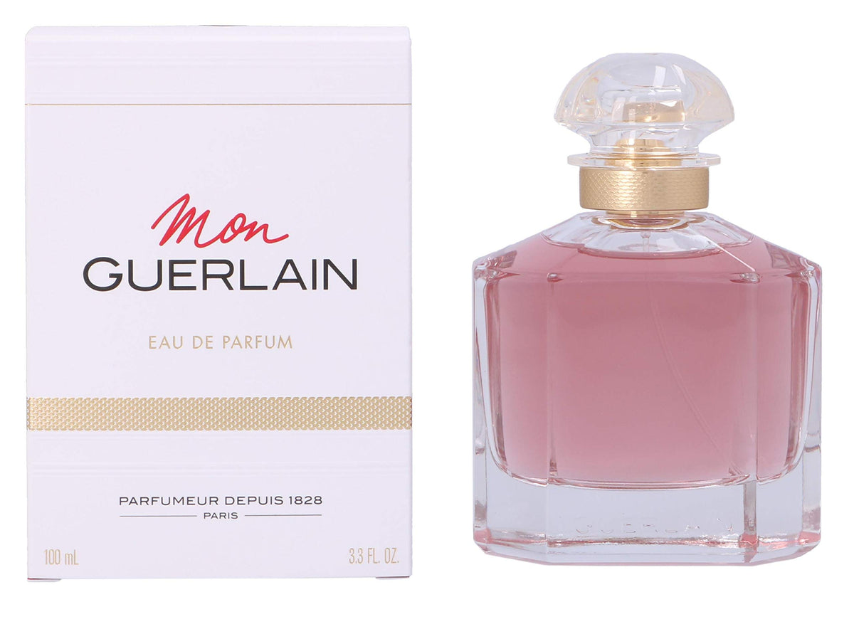 Guerlain Mon Guerlain 3.3 oz beside everyday items showing compact travel-friendly size