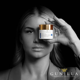 Gunilla jar next to coin to show the two-ounce size and travel-friendly benefit