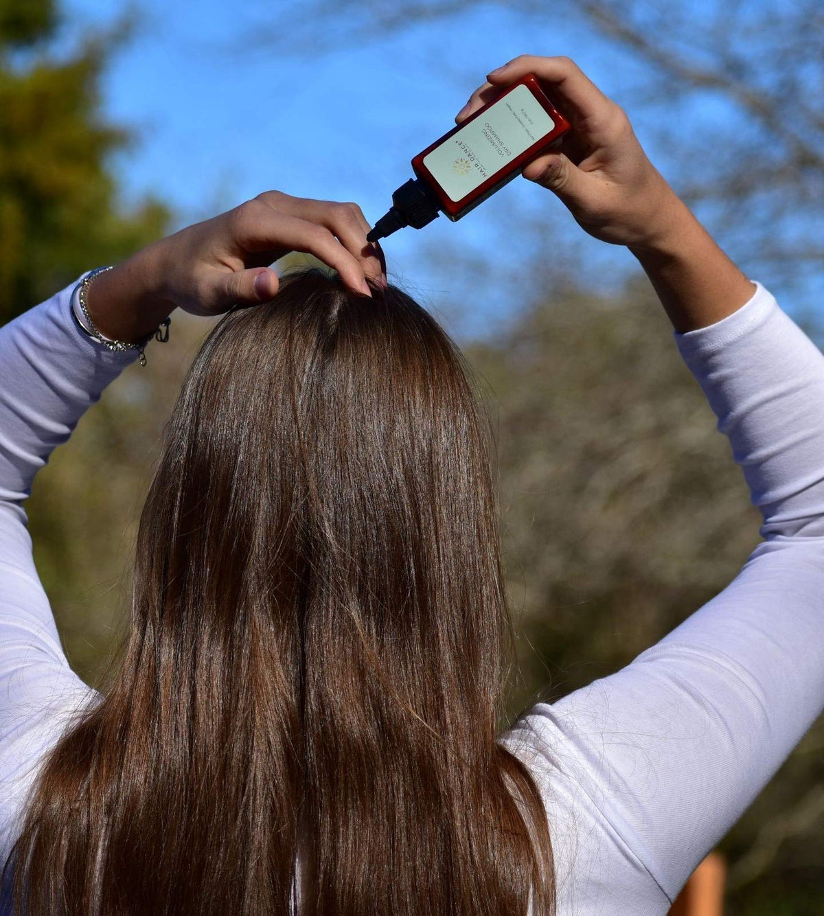 Hair Dance jar in hand showing 2 oz size and travel convenience