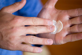 Hand applying Hair Dough to hair for effortless styling and quick control benefit