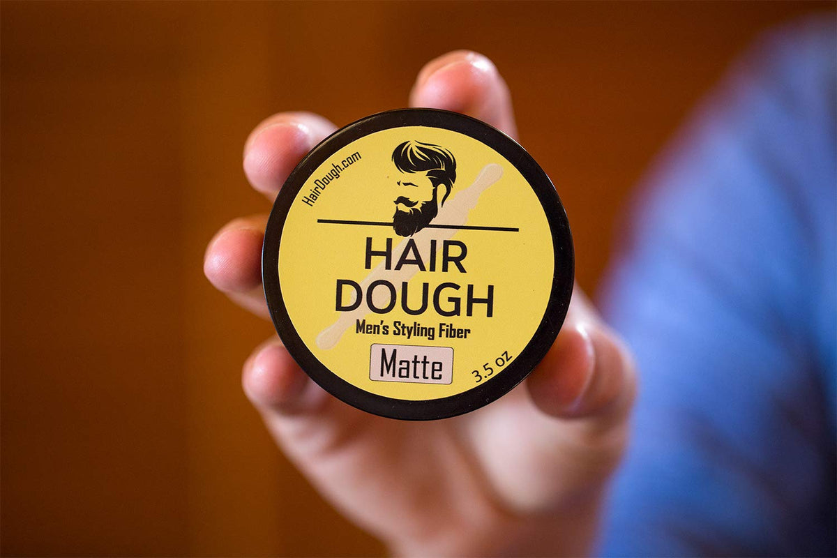 Hair Dough next to ruler and hand for size and scale clarity benefit