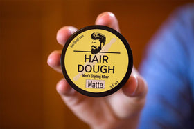 Hair Dough next to ruler and hand for size and scale clarity benefit