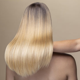 Hair Rituel by Sisley oil being applied to mid-lengths showing smoothing benefit