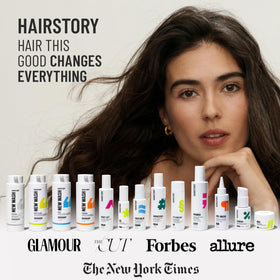 Hairstory Primer next to a hand demonstrating 8 fl oz scale and travel convenience
