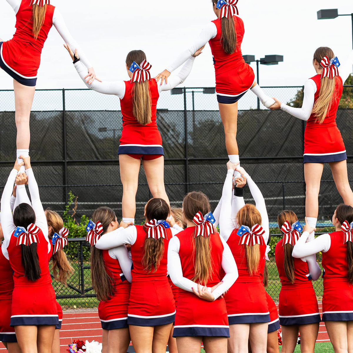 Hanaive bow worn in a cheerleader ponytail showing active-use stability