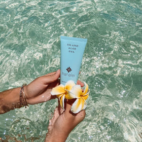 Hanalei next to passport showing travel-friendly 2.7 oz size