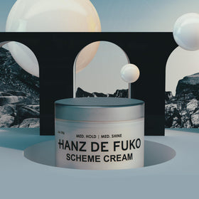 Hanz de Fuko travel-size jar next to passport for easy-packing convenience