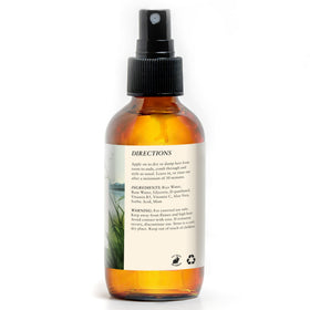 HAPPIE HUMMINGBYRD bottle in hand illustrating the convenient 4oz travel size