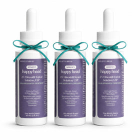 Happy Head front packaging shot showing clear 2% minoxidil bottles and label benefit