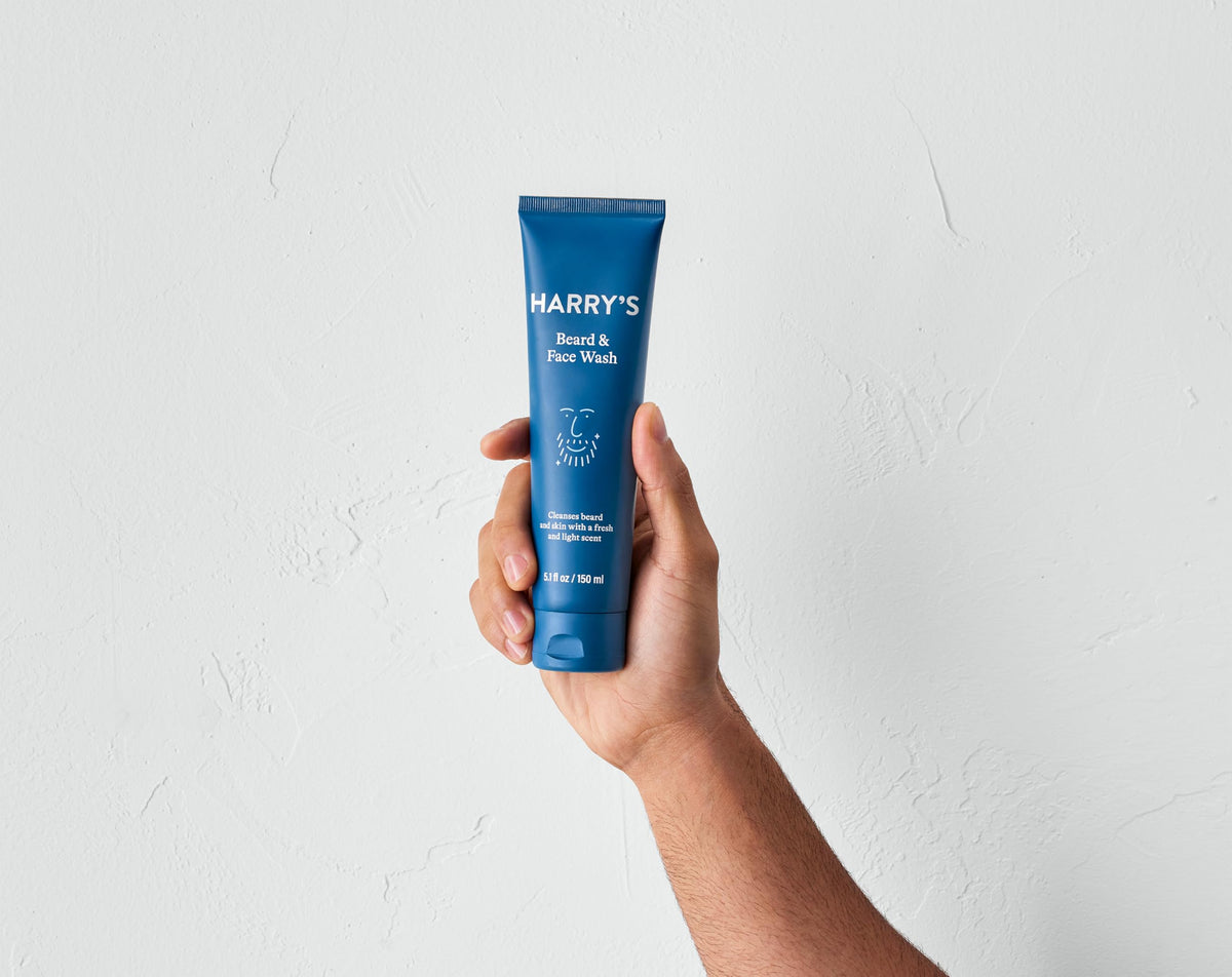 Man applying Harry's beard wash in shower, shows effective in-shower use