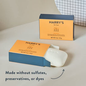 Harry's bar beside a razor for scale to show 4 oz size and travel-friendly convenience