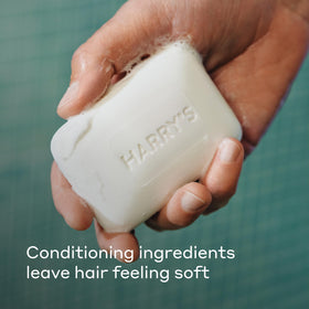 Harry's Stone soap lather in hand demonstrating rich creamy suds for cleansing