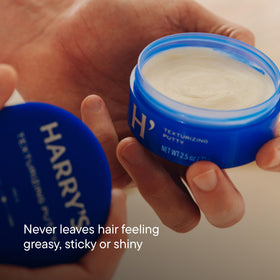 Close-up of fingers with Harry's putty demonstrating quick absorption