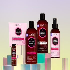 HASK bottles held in hand to show scale and travel-friendly size