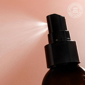 HASK creamy leave-in texture on hand highlighting lightweight absorption benefit