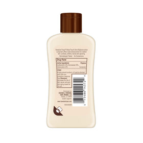Person applying Hawaiian Tropic at the beach illustrating easy reapplication