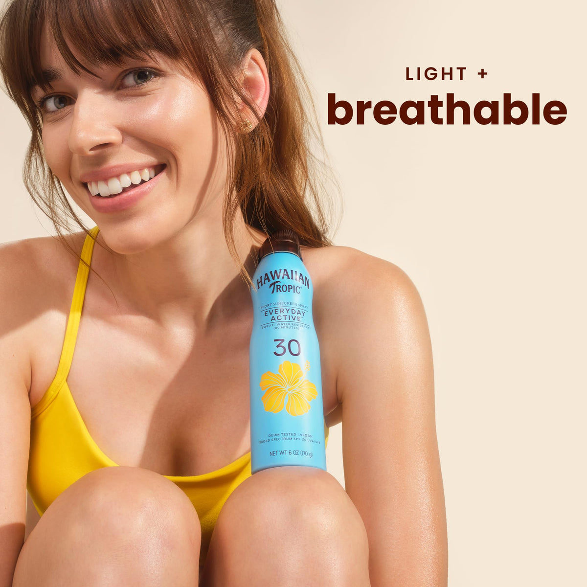 Hawaiian Tropic clear mist spraying on arm for fast, invisible coverage