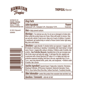 Hawaiian Tropic lip balm next to a coin to show compact 0.14 oz size