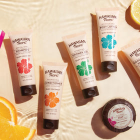 Hawaiian Tropic tubes next to passport showing TSA-friendly travel size