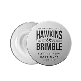 Hawkins & Brimble rinsing hair to show easy washout and low-residue finish after styling