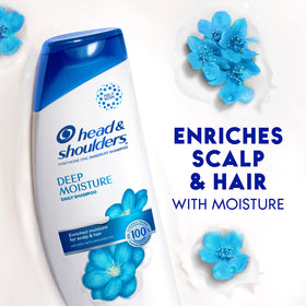 Head & Shoulders bottle held in hand showing 12.8 fl oz scale and portability