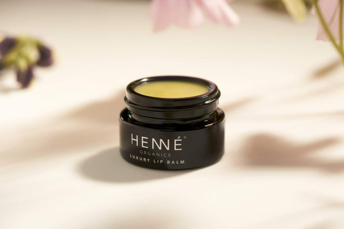 HennÃ Organics lip balm in a lifestyle setting showing everyday protective use
