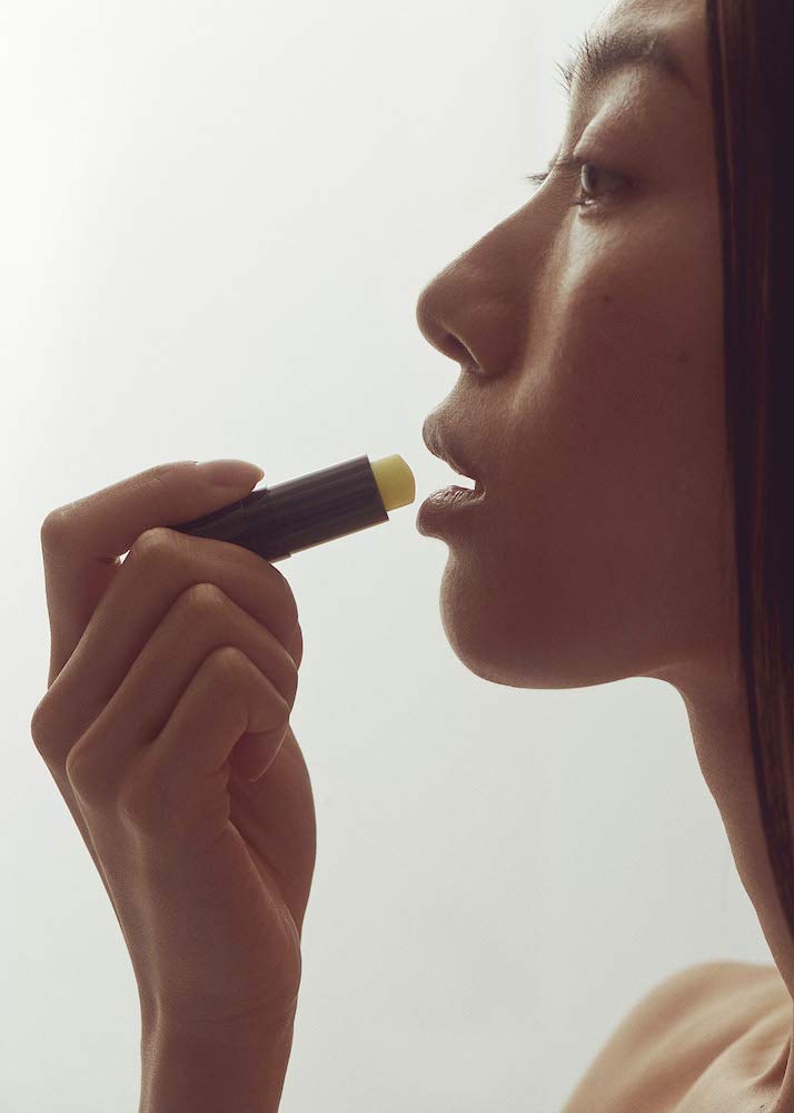 Henné Organics open cap revealing balm stick and easy application benefit
